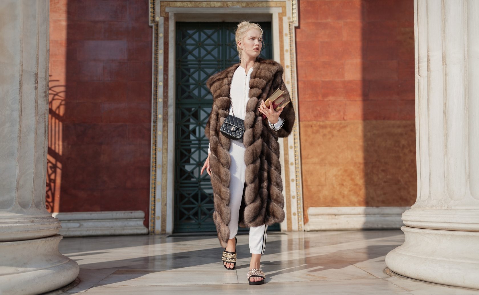 Marco Varni sable coat photographed against classical Greek columns
